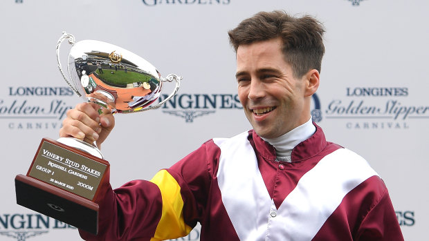 Adam Hyeronimus holds up the Vinery Stud Stakes trophy after Shout The Bar's victory.