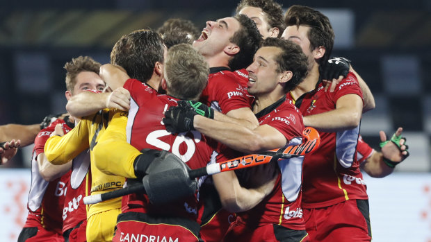 Belgian players celebrate their win over Netherlands in the gold medal game at the Men's Hockey World Cup at Kalinga Stadium in Bhubaneswar, India on Sunday.