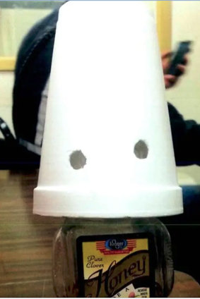 A honey bottle made up to look like a Ku Klux Klan member was allegedly left in the breakroom at Pinto Mining Group.