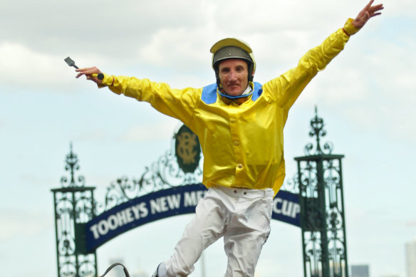 Damien Oliver jumping off Media Puzzle after his incredible 2002 Melbourne Cup win.