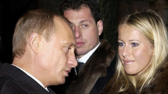Russian President Vladimir Putin, left, speaks to Ksenia Sobchak, daughter of former St Petersburg mayor Anatoly Sobchak in 2003.