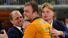  Harry Wilson of the Wallabies celebrates with Phil and Charlie Waugh.