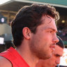 Oliver Florent of the Swans and team mates run onto the field at the SCG