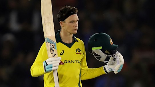 Peter Handscomb celebrates scoring a century during the one-day international between India and Australia in Mohali on Sunday.