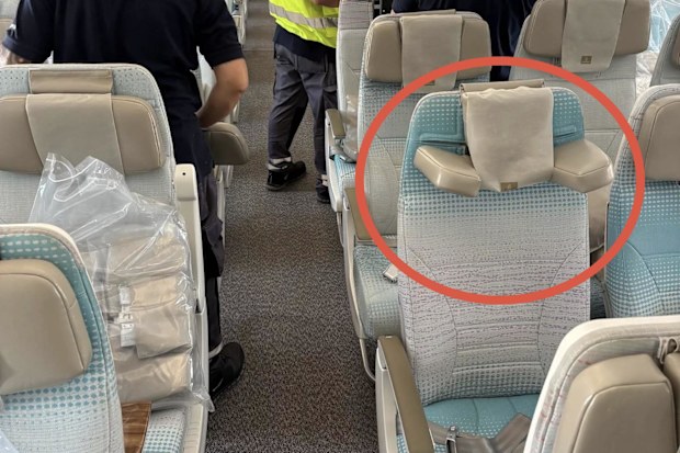 A plane cabin - the seats have new headrests which fold down to cradle the neck