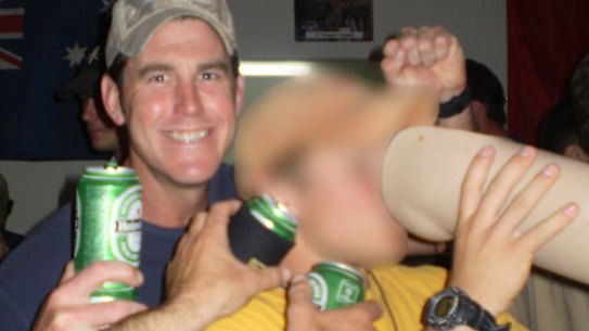 Ben Roberts-Smith (left) with a former colleague drinking from the prosthetic leg of a dead Afghan man in 2012.