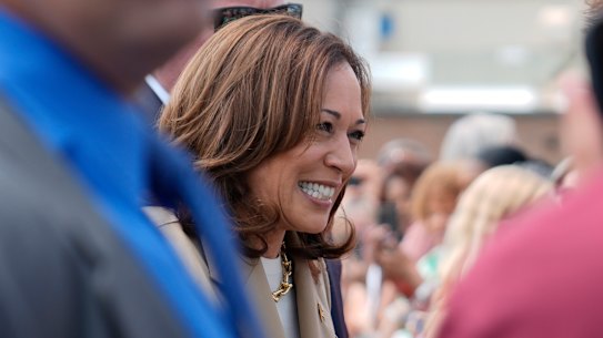 Vice President Kamala Harris greets supporters as she arrives at Westfield-Barnes Regional Airport in Westfield, Massachusetts.