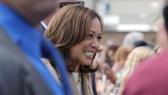 Vice President Kamala Harris greets supporters as she arrives at Westfield-Barnes Regional Airport in Westfield, Massachusetts.