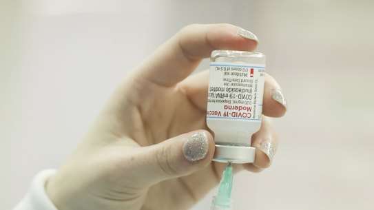 A pharmacist preparing a dose of Moderna vaccine. 