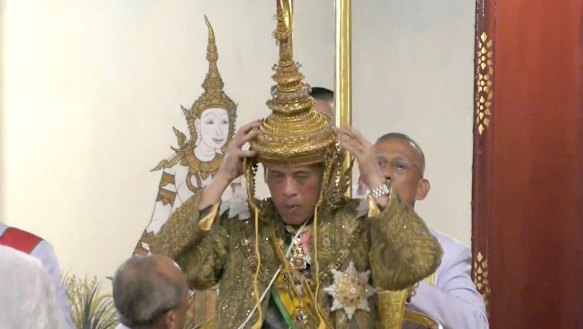Thai King Maha Vajiralongkorn adjusts his crown at his coronation on Saturday.