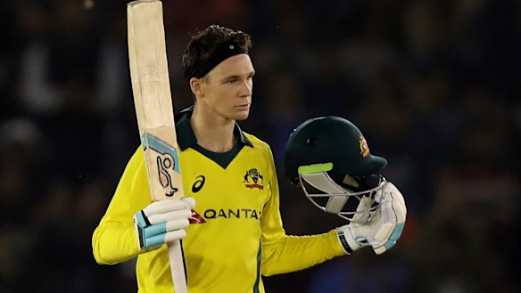Peter Handscomb celebrates scoring a century during the one-day international between India and Australia in Mohali on Sunday.
