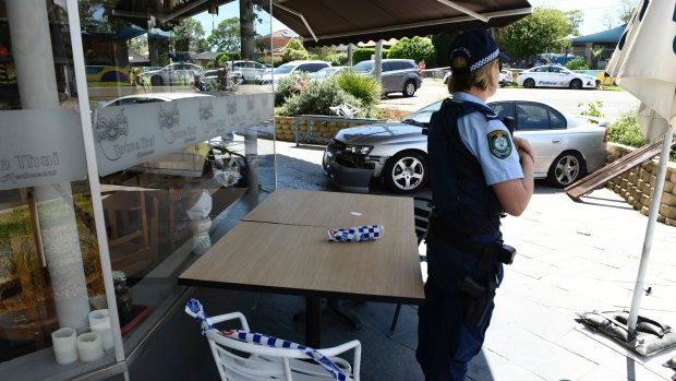 Police officers at the scene of the car accident in North Epping on Friday. 