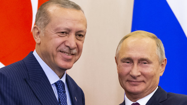 Russian President Vladimir Putin, right, and Turkish President Recep Tayyip Erdogan shake hands after their joint news conference following the talks in Sochi, Russia, 
