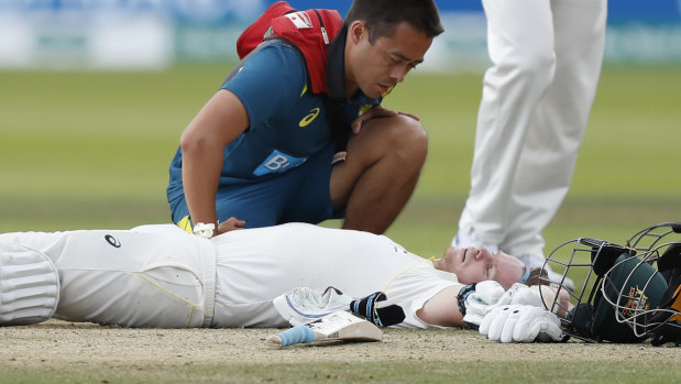 Steve Smith receives treatment after being hit on the side of the neck on day four of the second Ashes Test.  