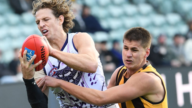 Fremantle captain Nat Fyfe and Hawthorn's Daniel Howe contest the ball in the round 17 clash in Launceston at the weekend. 