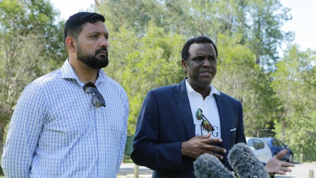 Family spokesman Ali Kadri with Raghe Abdi’s father, Mohammad, at Calamvale District Park on Friday, December 18. 