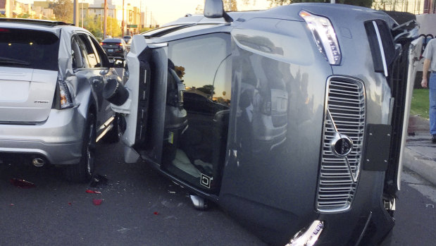 An Uber self-driving car that flipped on its side in a collision in Arizona.