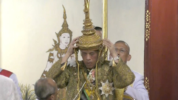 Thai King Maha Vajiralongkorn adjusts his crown at his coronation on Saturday.
