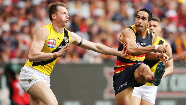 Eddie Betts snaps at goal for the Crows under pressure from Tigers defender Dylan Grimes in the 2017 grand final.