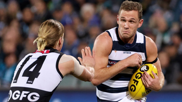 Joel Selwood braces for contact with Port’s Miles Bergman.