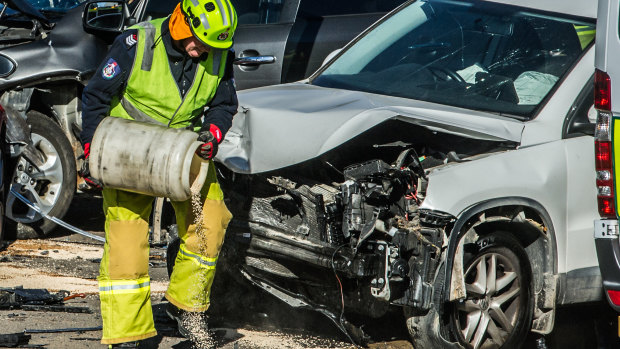 Firefighters work at the scene of a four-car crash in Fyshwick on Wednesday morning.