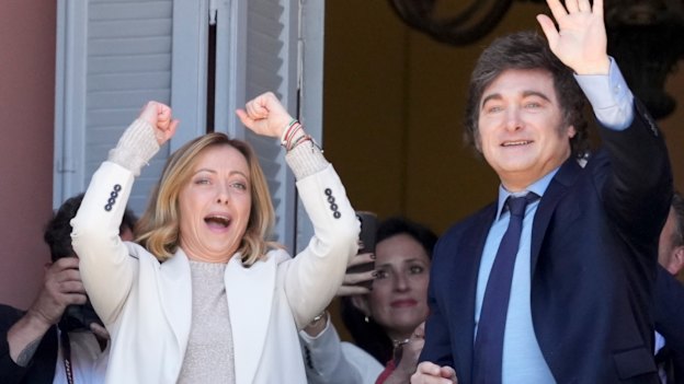 Italian Prime Minister Giorgia Meloni (left) and Argentine President Javier Milei wave to supporters from a government house balcony, in Buenos Aires in November.