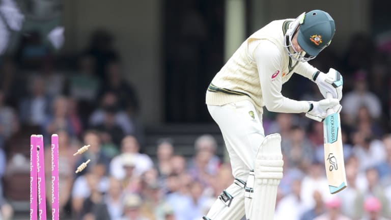 Skittled: Peter Handscomb's resistance comes to an end when he is bowled by Jasprit Bumrah.