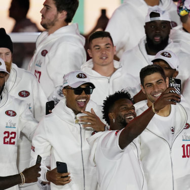 San Francisco 49ers take selfies after arriving in Miami ahead of the Super Bowl.