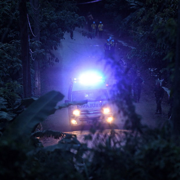 An ambulance races through the forest with one of the rescued boys on board. 