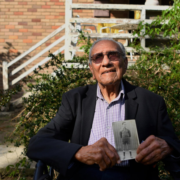Isaac Bates is the oldest living Redfern All Black. He is holding a photo of himself age 17 when he joined the club.
