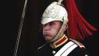A member of the Queen's Lifeguard marches at Horseguards as temperatures rise far above 30 Celsius in London.