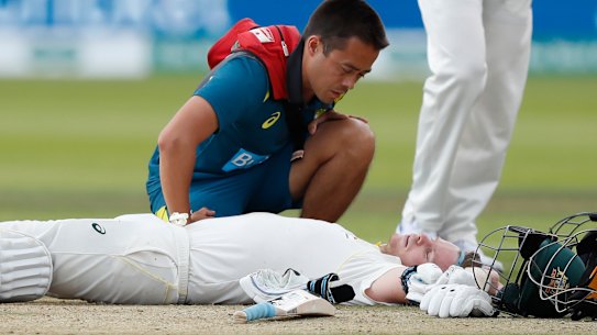 Steve Smith receives medical assistance after being hit in the neck by Jofra Archer. He left the field but returned to bat once Peter Siddle was dismissed. 