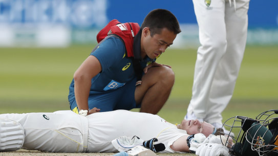 Steve Smith receives treatment after being hit on the side of the neck in day four of the second Ashes Test. 