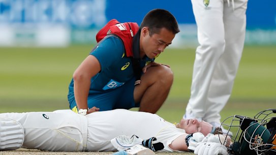 Steve Smith receives medical assistance after being hit in the neck by Jofra Archer. He left the field but returned to bat once Peter Siddle was dismissed. 
