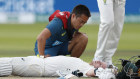 Steve Smith receives treatment after being hit on the side of the neck on day four of the second Ashes Test.  