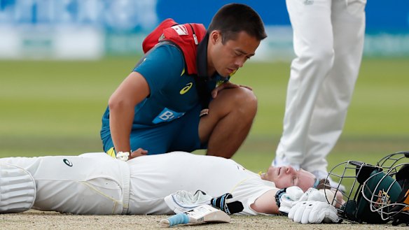 Steve Smith receives medical assistance after being hit in the neck by Jofra Archer. He left the field but returned to bat once Peter Siddle was dismissed. 