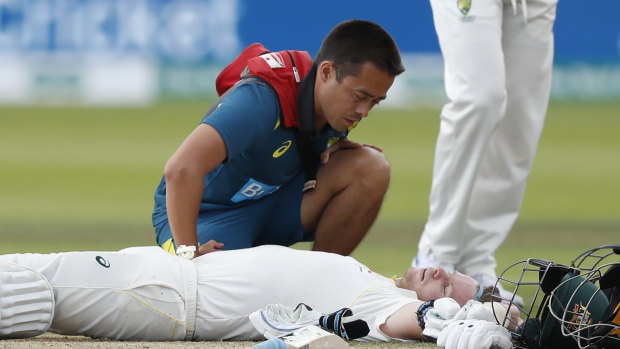 Steve Smith receives medical assistance after being hit in the neck by Jofra Archer. He left the field but returned to bat once Peter Siddle was dismissed. 