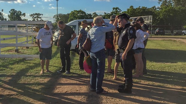 Police speaking to witnesses and convoy members after the incident.