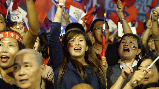 Supporters of the opposition nationalist KMT celebrate in Kaohsiung, Taiwan, on Saturday. 