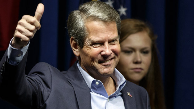 Republican gubernatorial candidate Brian Kemp gives a thumbs-up as he greets the crowd during a rally in Dalton, Georgia. 