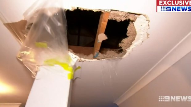 The hole caused by the man falling through the ceiling.