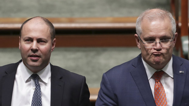 Scott Morrison and Josh Frydenberg ... softening the ground as the chances of a budget surplus diminish.