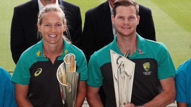 Australian cricketers Meg Lanning and Steve Smith with the women's and men's Twenty20 World Cup trophies.