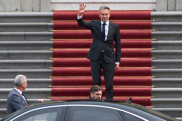 Dutch Prime Minister Dick Schoof waves after handing in the resignation of Geert Wilder’s PVV party ministers to King Willem-Alexander.