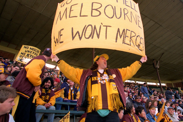 A Hawthorn fan makes his displeasure known about the proposed merger.