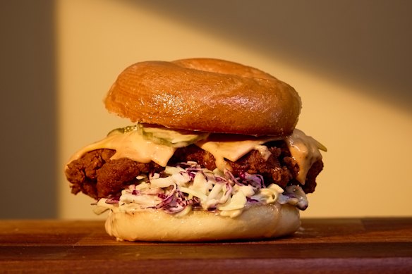 “The Tokyo” fried chicken bagel with cabbage slaw, provolone cheese and chilli-mayo at Roman’s Deli.
