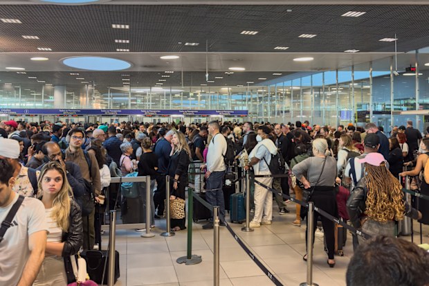 Queues of passengers at Lisbon Humberto Delgado Airport Arrivals waiting for immigration border control processing for up to 3 hours in June 2025