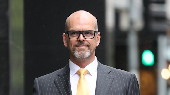 Former police chief commissioner Simon Overland walks in to testify before the Lawyer X Royal Commission.