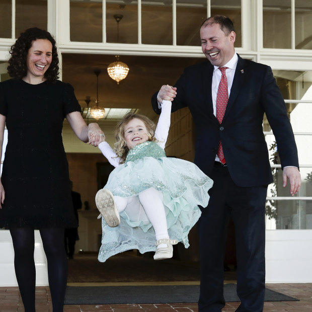 Josh Frydenberg and wife Amie swing daughter Gemma after the new Treasurer was sworn in at Government House. 