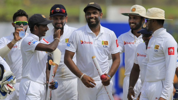 Spun out: Sri Lanka's Dilruwan Perera is congratulated by teammates after the defeat of South Africa.